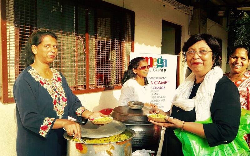 Volunteers and partner organisations serving at a health camp